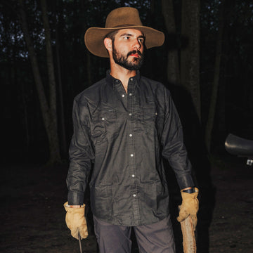 Man Holding Fire Wood Wearing Matamoros shirt