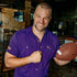 Man holding football wearing LSU purple shirt