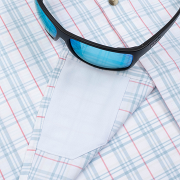 sunglasses and lens cleaner on shirt