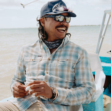 Man laughing while on a boat
