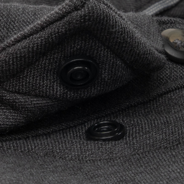 Close-up of black snap button detail on dark textured fabric of The Nighthawk shirt, showcasing quality stitching.