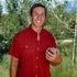 man holding football wearing red short sleeve shirt