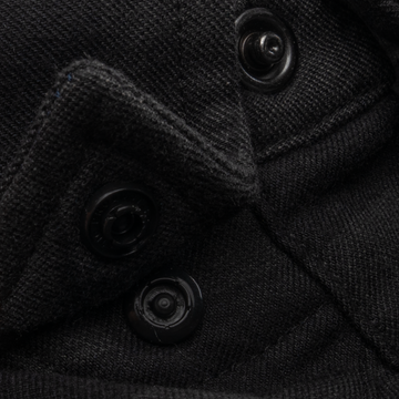 Close-up of black snaps and fabric detail on The North Rim shirt, highlighting rugged outdoor style.