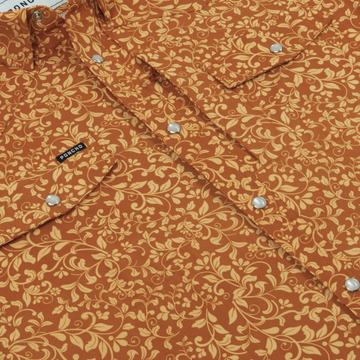 Close-up of The Occupy Left Field shirt featuring a warm floral pattern and snap button details.