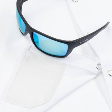 Closeup of sunglasses with lens cleaner on shirt
