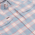 Close-up of a soft plaid button-up shirt in pastel blue and pink tones called The Pacific City, highlighting snap pockets.