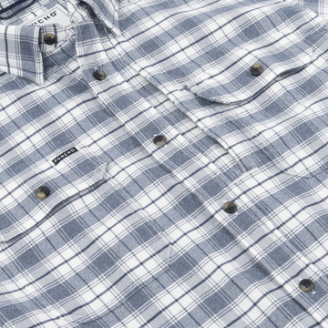 Close-up of The Pagosa shirt in blue and white plaid with button details and chest pockets.