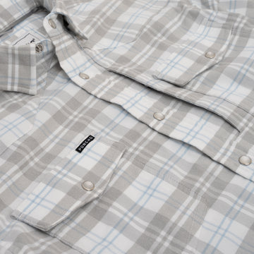 close up photo of blue and grey pearl snaps chest pocket with hidden zipper pocket