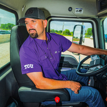 man driving truck wearing purple TCU shirt