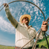 man roping wearing tan long sleeve shirt