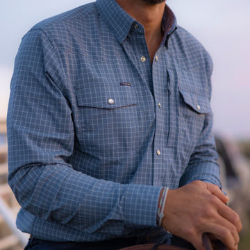 closeup of man wearing slate blue check long sleeve shirt