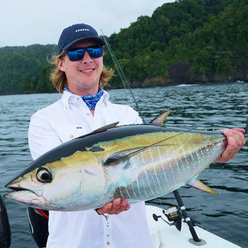 man holding fish wearing the salty dog shirt