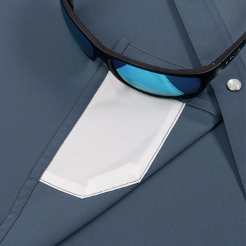 Close-up of The Sardine shirt pocket with stylish blue sunglasses resting on it