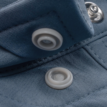 Close-up of a snap button on The Sardine shirt fabric