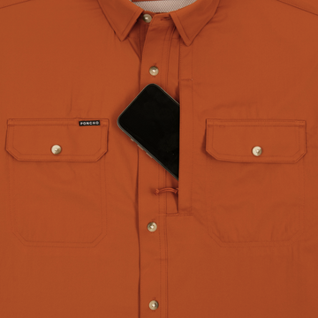 Phone in chest zipper pocket of shirt