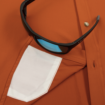 Closeup of sunglasses with lens cleaner on shirt