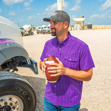man holding football wearing stockyard shirt