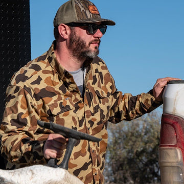Man holding something wearing the stuttgart shirt