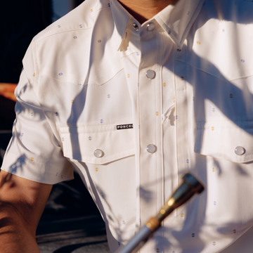 man holding trumpet wearing the tchoupitoulas shirt