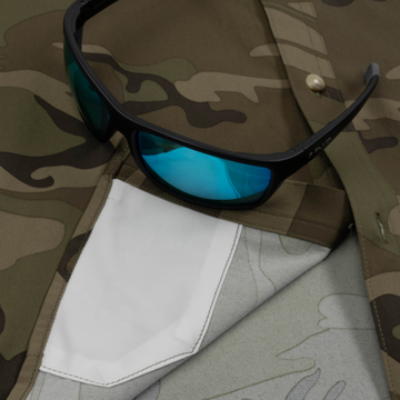 Closeup of sunglasses with lens cleaner on shirt