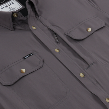 Close-up of The Tripletail shirt showing purple fabric with buttoned chest pockets and zipper detail