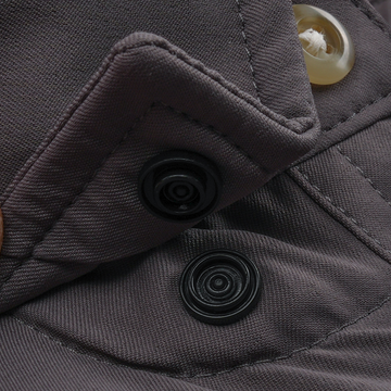 Close-up of durable button and snap fastener details on The Tripletail shirt in dark fabric