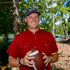 man wearing red short sleeve shirt holding football