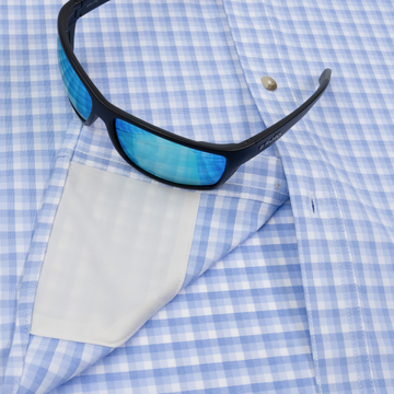 Closeup of sunglasses with lens cleaner on shirt