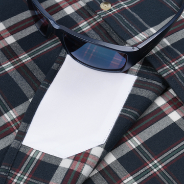 Close-up of The Willamette plaid shirt pocket with sunglasses resting on top