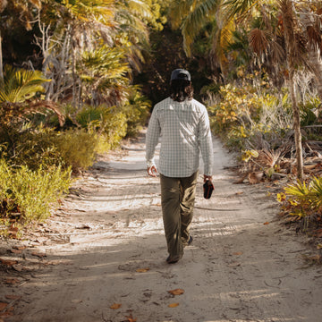 Man walking down dirt road in 12 Weight shirt