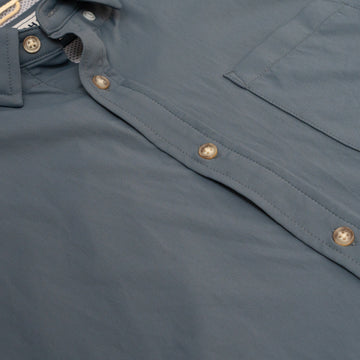 Close up photo of slate blue buttons and chest pocket