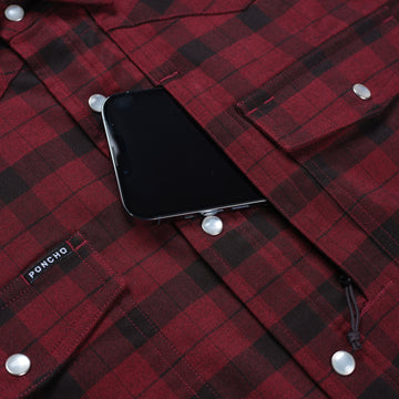 phone in pocket of red and black flannel pearl snap