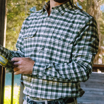 Man holding fly rod on porch in The Copperhead