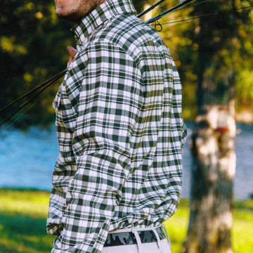 Man carrying fly rods in The Copperhead