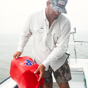 man filling boat up with gas in The Cumberland shirt