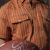 Close-up of brown breathable outdoor shirt The Earl with snap pockets and subtle dot pattern