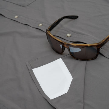 Sunglasses on shirt with hidden sunglass cleaner fabric