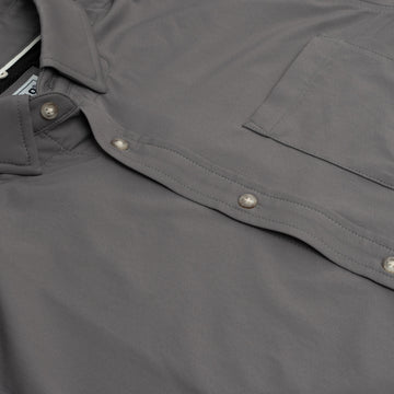 close up product photo of buttons and pockets on grey button down shirt