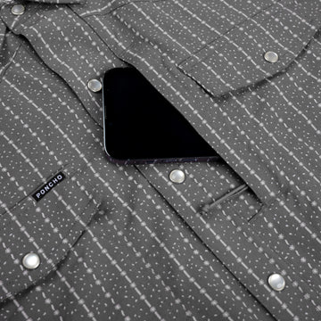 closeup of phone going into chest pocket
