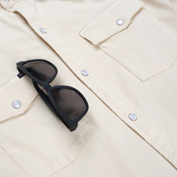 Detail shot of white denim shirt with sunglasses holder