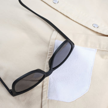 Detail shot of lens cloth and sunglasses