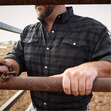 Man wearing shirt while working at ranch