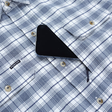 phone in pocket of blue plaid shirt