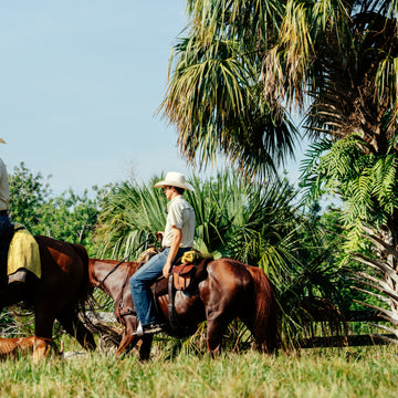 man riding horse wearing tan short sleeve tuff-thread shirt