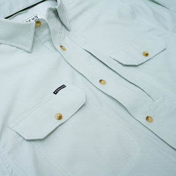 close up photo of chest pockets on micro grid green shirt