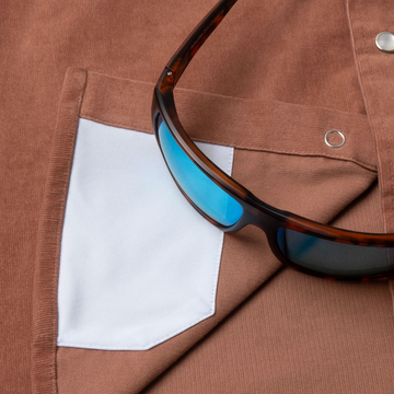 sunglasses with lens cleaner on shirt