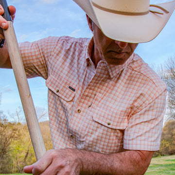 closeup of man wearing short sleeve red plaid shirt