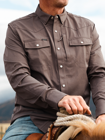 Man riding horse in grey shirt
