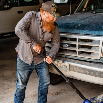 Man jacking up a truck to fix the tire