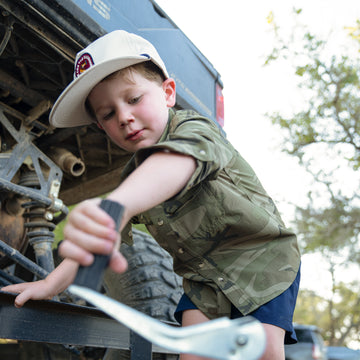 kid wearing camo short sleeve button down
